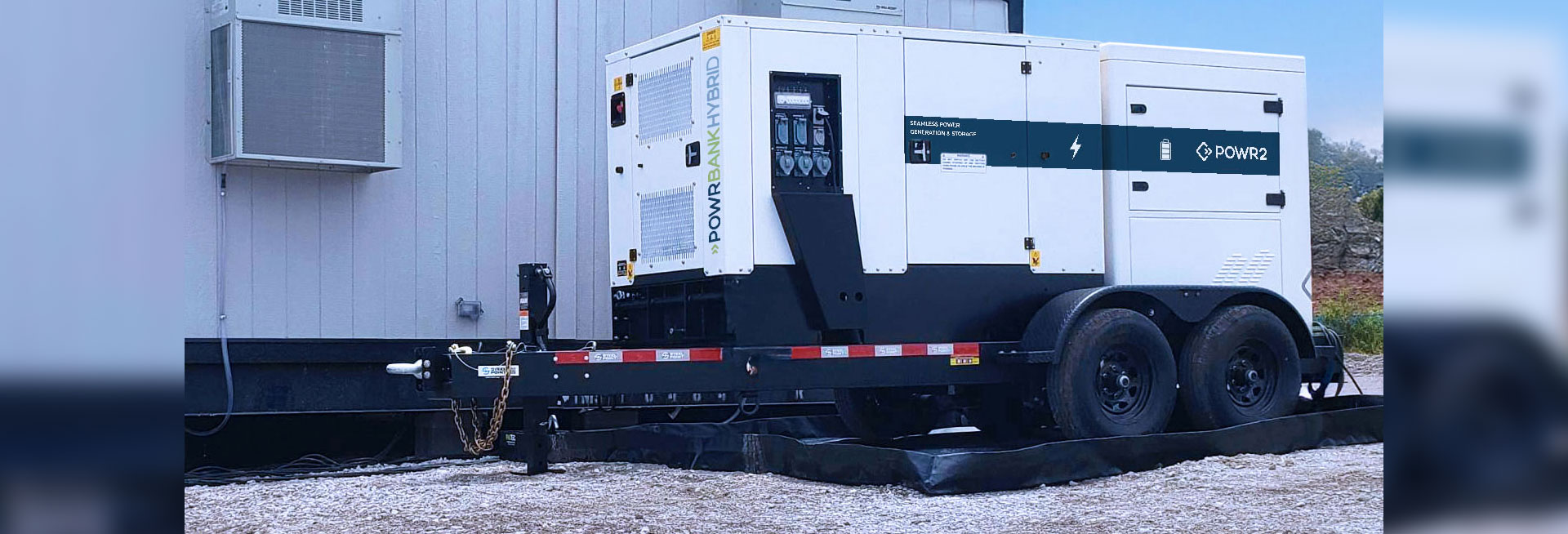 POWRBANK HYBRID - Hybrid Power, BESS + Generator - connected to an office trailer in a construction site